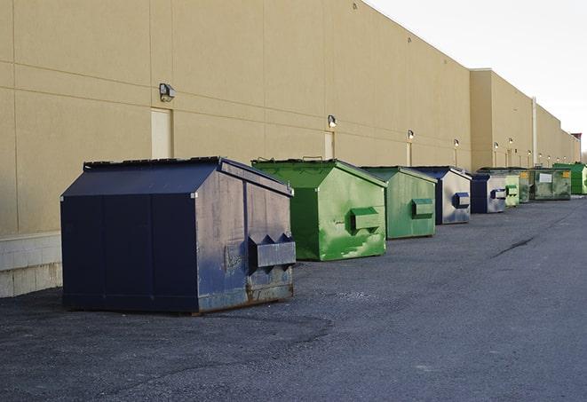 a row of blue construction dumpsters on a job site in Allendale